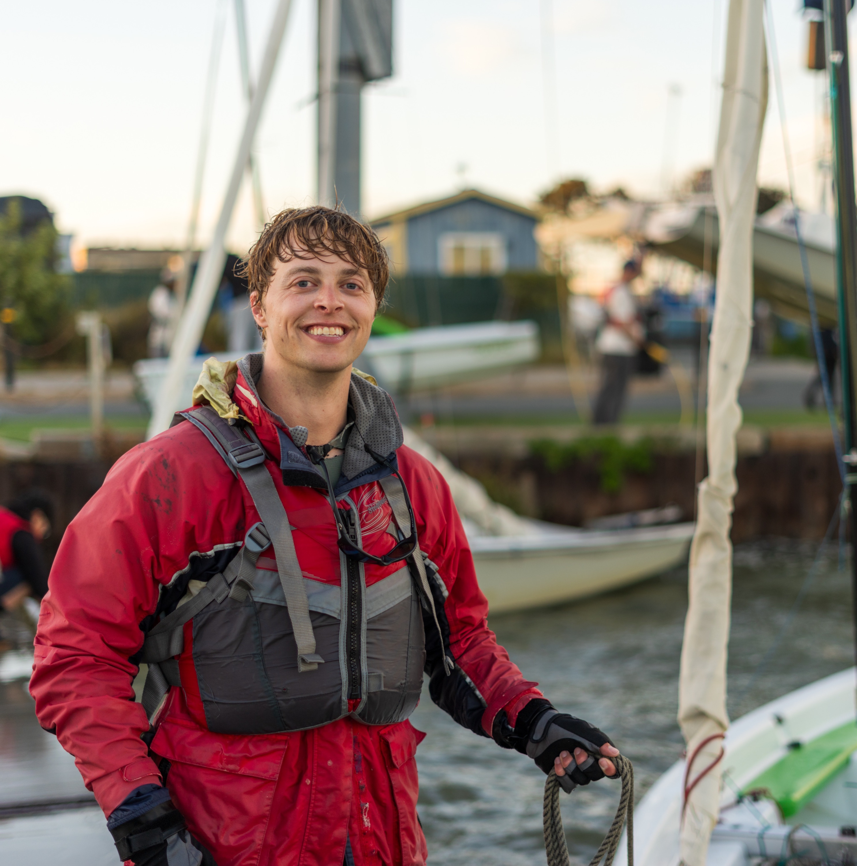 Griffith Baker in sailing gear beside a sailboat
